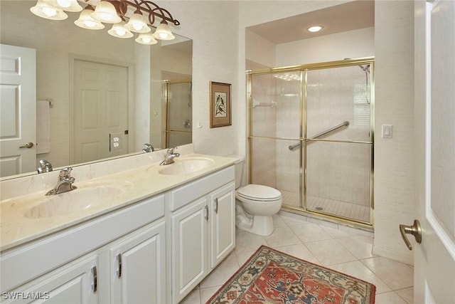 bathroom featuring a shower stall, tile patterned floors, and a sink