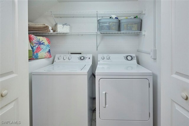 clothes washing area featuring washing machine and clothes dryer and laundry area