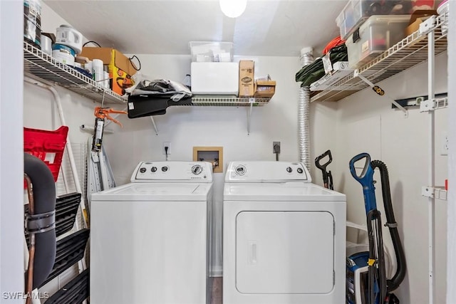 clothes washing area with separate washer and dryer and laundry area