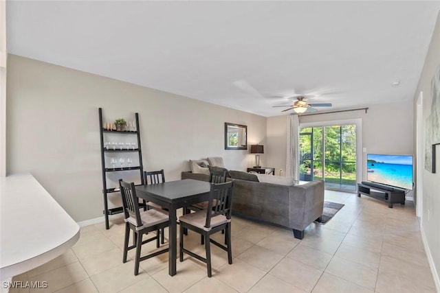dining area with baseboards, light tile patterned floors, and a ceiling fan