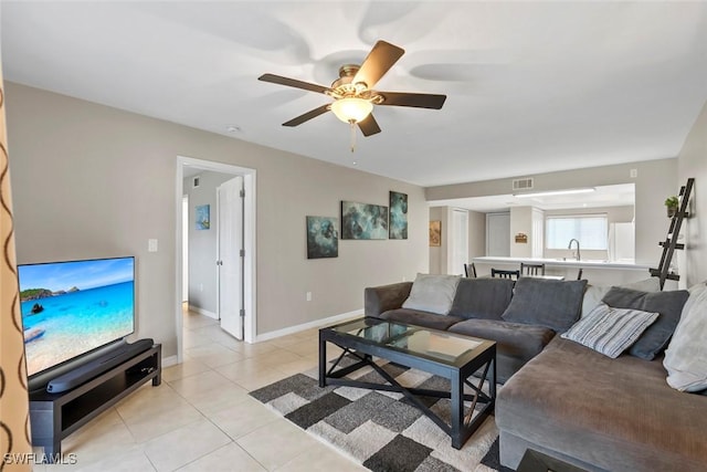 living room with light tile patterned floors, ceiling fan, baseboards, and visible vents