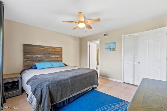 bedroom featuring light tile patterned floors, a closet, ceiling fan, baseboards, and visible vents