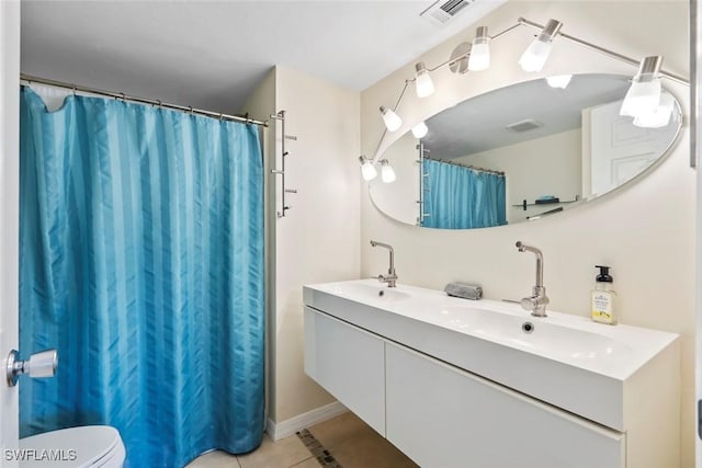full bathroom with tile patterned flooring, double vanity, toilet, a sink, and visible vents