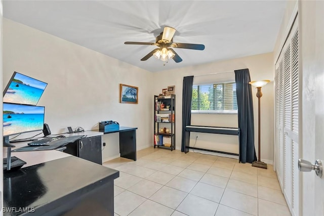 office area featuring baseboards, light tile patterned floors, and a ceiling fan