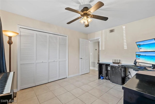 office area with light tile patterned floors, a ceiling fan, visible vents, and baseboards