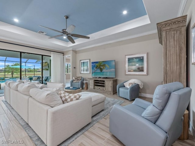 9459 Campanile Cir, Naples, FL 34114 - living room with a raised ceiling, a ceiling fan, crown molding, baseboards, and recessed lighting