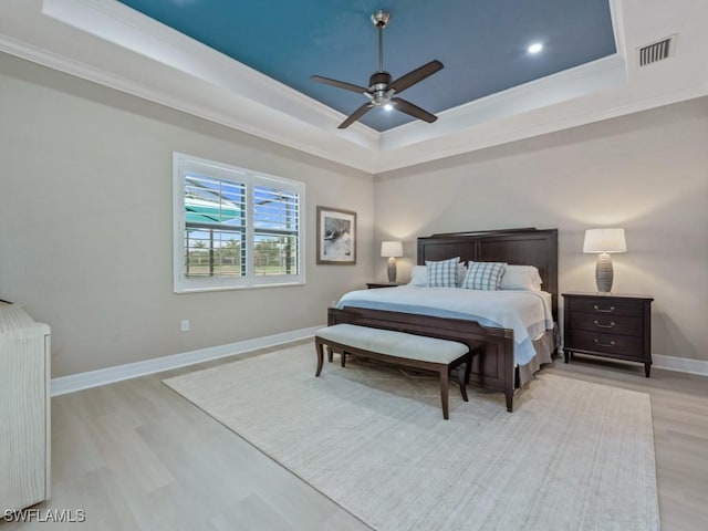 9459 Campanile Cir, Naples, FL 34114 - bedroom featuring a raised ceiling, ornamental molding, light wood-type flooring, baseboards, and a ceiling fan