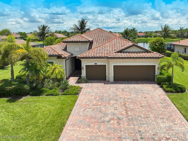 9459 Campanile Cir, Naples, FL 34114 - mediterranean / spanish-style house featuring an attached garage, a front lawn, stucco siding, decorative driveway, and a tiled roof