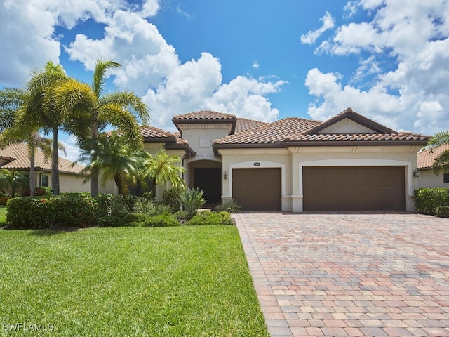 9459 Campanile Cir, Naples, FL 34114 - mediterranean / spanish house with a garage, a front lawn, stucco siding, driveway, and a tiled roof