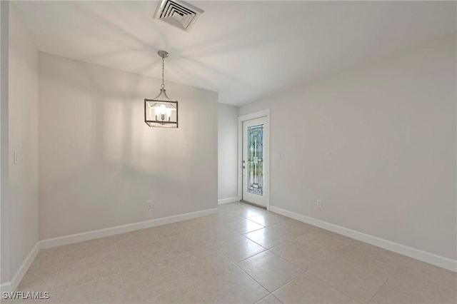 5 Rivard Rd Unit 22, Naples, FL 34112 - empty room featuring a chandelier, light tile patterned flooring, and baseboards