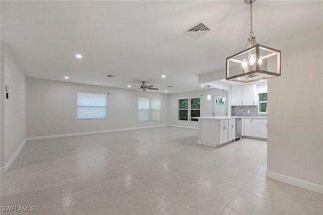 5 Rivard Rd Unit 22, Naples, FL 34112 - kitchen with open floor plan, a chandelier, white cabinetry, dishwasher, and hanging light fixtures