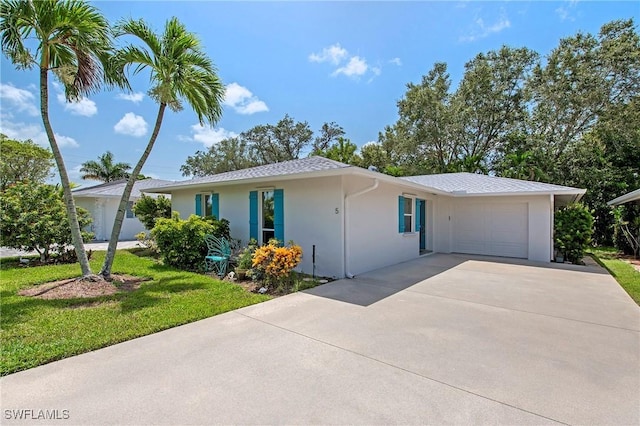 5 Rivard Rd Unit 22, Naples, FL 34112 - single story home with driveway, an attached garage, stucco siding, and a front yard