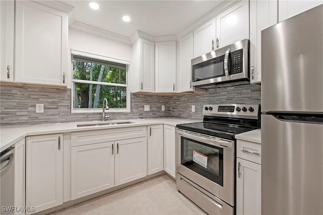 5 Rivard Rd Unit 22, Naples, FL 34112 - kitchen with appliances with stainless steel finishes, a sink, white cabinetry, light countertops, and recessed lighting