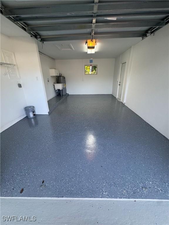 5 Rivard Rd Unit 22, Naples, FL 34112 - garage featuring a garage door opener and water heater