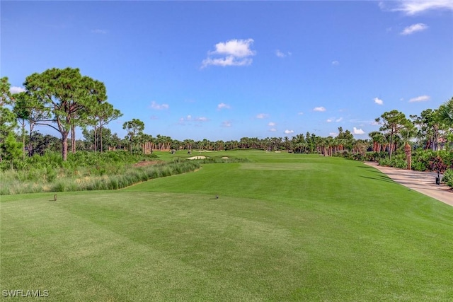 24748 Lakemont Cove Ln Unit 201, Bonita Springs, FL 34134 - view of property's community featuring golf course view, view of wooded area, and a lawn