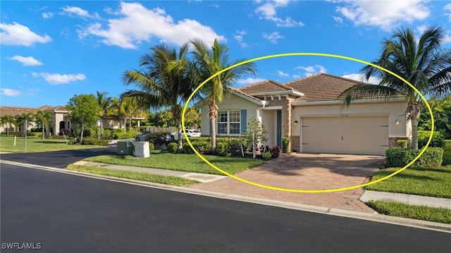 15030 Cortona Way, Fort Myers, FL 33908 - view of front of property featuring a tiled roof, a front lawn, stucco siding, an attached garage, and decorative driveway