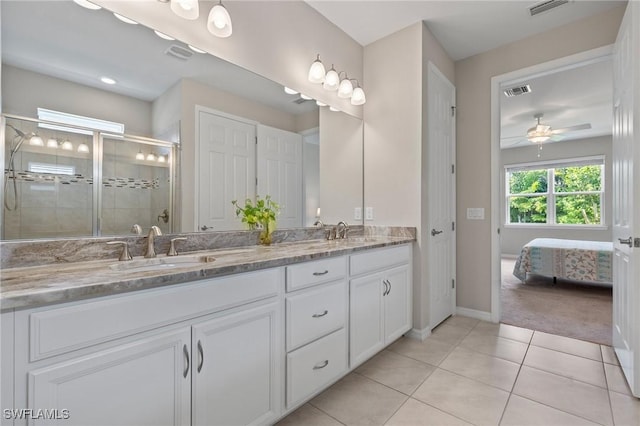 15030 Cortona Way, Fort Myers, FL 33908 - bathroom featuring a shower stall, tile patterned floors, double vanity, a sink, and baseboards