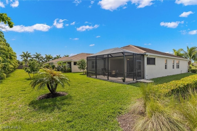 15030 Cortona Way, Fort Myers, FL 33908 - rear view of property featuring stucco siding, a lawn, a patio, and a lanai