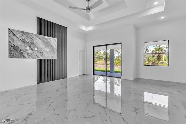 1025 Gladys St, Lehigh Acres, FL 33974 - spare room featuring marble finish floor, ceiling fan, a raised ceiling, a high ceiling, and recessed lighting