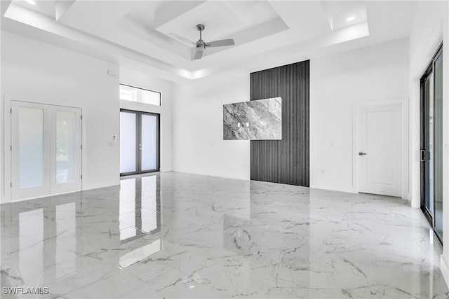 1025 Gladys St, Lehigh Acres, FL 33974 - spare room featuring ceiling fan, marble finish floor, french doors, a tray ceiling, and a high ceiling