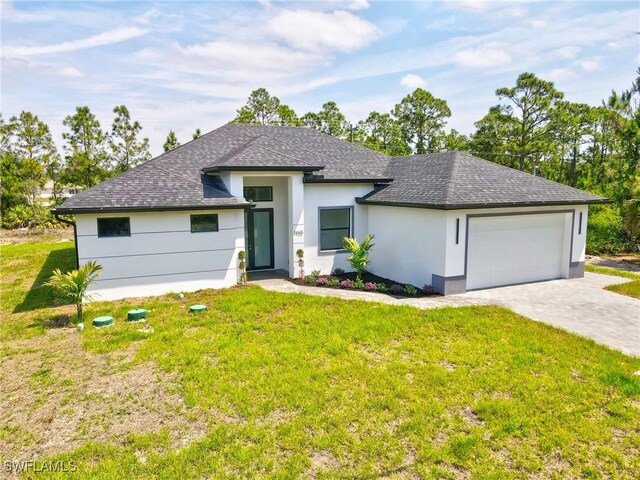 1025 Gladys St, Lehigh Acres, FL 33974 - view of front of property with roof with shingles, a garage, a front yard, stucco siding, and decorative driveway