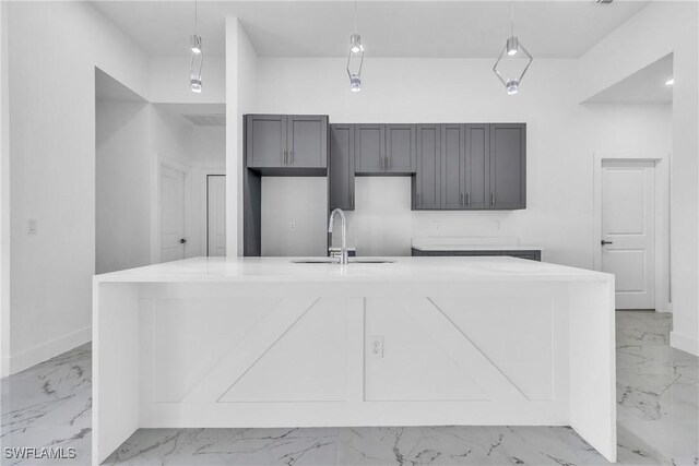 1025 Gladys St, Lehigh Acres, FL 33974 - kitchen featuring decorative light fixtures, marble finish floor, a sink, and a large island