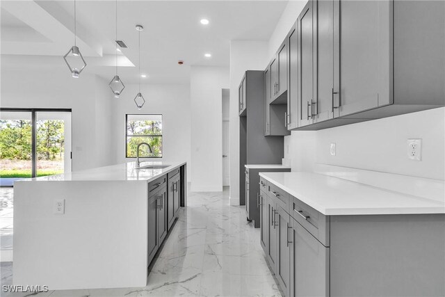 1025 Gladys St, Lehigh Acres, FL 33974 - kitchen with recessed lighting, marble finish floor, an island with sink, gray cabinets, and a sink