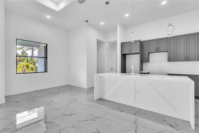 1025 Gladys St, Lehigh Acres, FL 33974 - kitchen featuring recessed lighting, marble finish floor, an island with sink, a sink, and pendant lighting