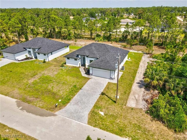 1025 Gladys St, Lehigh Acres, FL 33974 - drone / aerial view with a wooded view