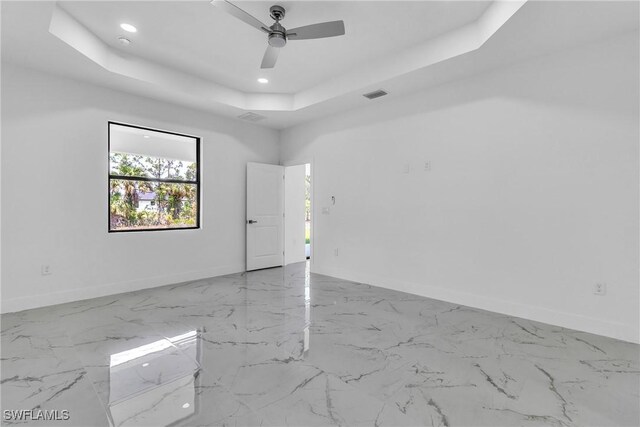 1025 Gladys St, Lehigh Acres, FL 33974 - empty room featuring ceiling fan, baseboards, visible vents, and a raised ceiling