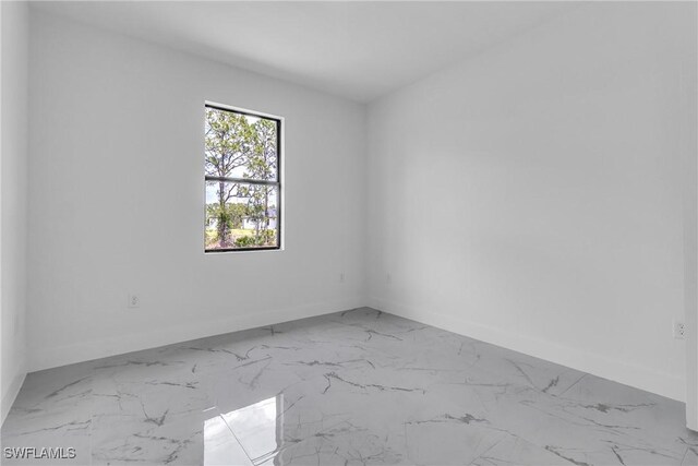 1025 Gladys St, Lehigh Acres, FL 33974 - spare room featuring baseboards and marble finish floor