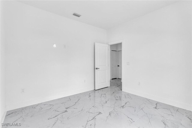 1025 Gladys St, Lehigh Acres, FL 33974 - spare room with visible vents, marble finish floor, and baseboards
