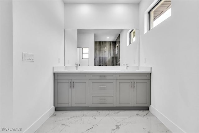 1025 Gladys St, Lehigh Acres, FL 33974 - bathroom featuring baseboards, a sink, and marble finish floor