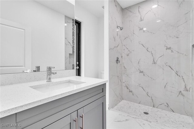 1025 Gladys St, Lehigh Acres, FL 33974 - bathroom featuring vanity and a marble finish shower