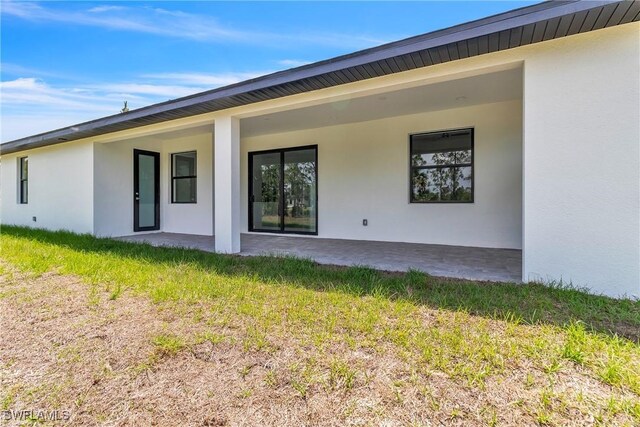 1025 Gladys St, Lehigh Acres, FL 33974 - back of property with stucco siding