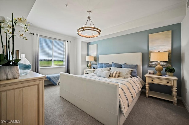 carpeted bedroom with crown molding and a chandelier
