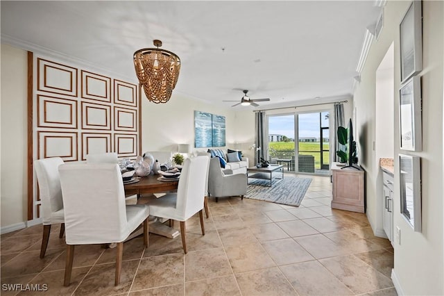dining area featuring ceiling fan with notable chandelier and crown molding