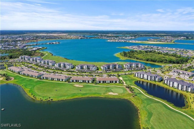 birds eye view of property featuring view of golf course and a water view