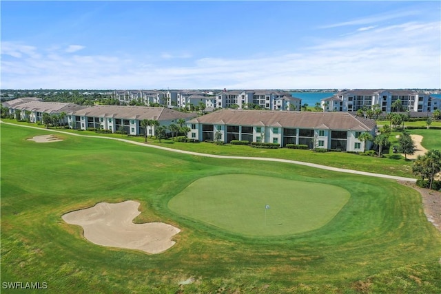 surrounding community with a yard, a water view, and golf course view