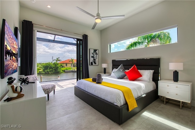 bedroom with access to exterior, a water view, and recessed lighting