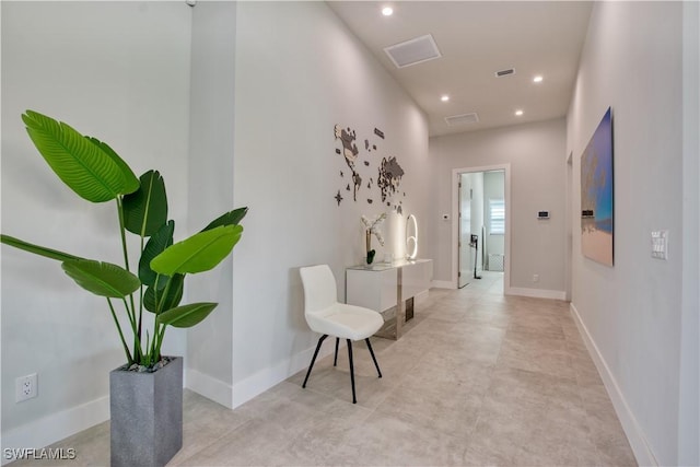 hallway with recessed lighting and baseboards
