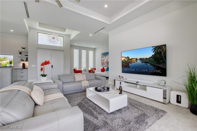 living room with a high ceiling and recessed lighting