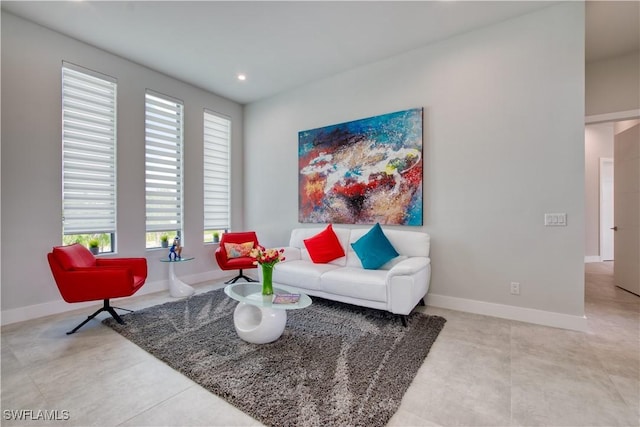 living area featuring baseboards and recessed lighting