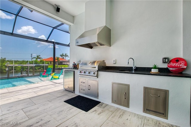 view of patio with an outdoor kitchen, a sink, grilling area, glass enclosure, and a swimming pool