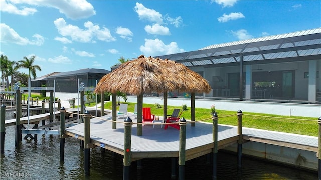 dock with boat lift, a water view, and a lanai