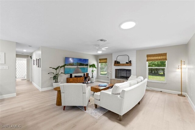 3795 Liberty Sq, Fort Myers, FL 33908 - living area featuring light wood finished floors, a fireplace, a ceiling fan, and baseboards
