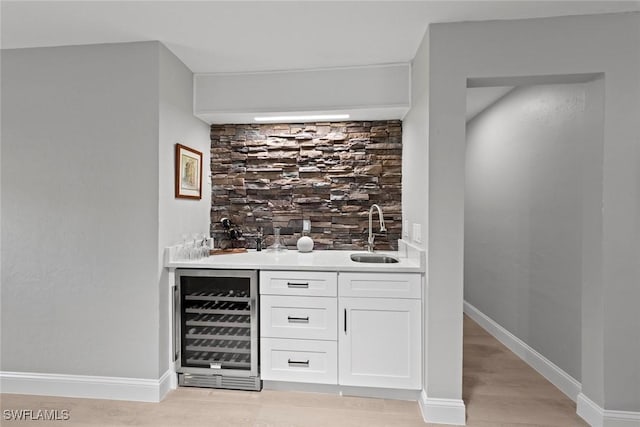3795 Liberty Sq, Fort Myers, FL 33908 - indoor wet bar with beverage cooler, light wood-style flooring, and baseboards