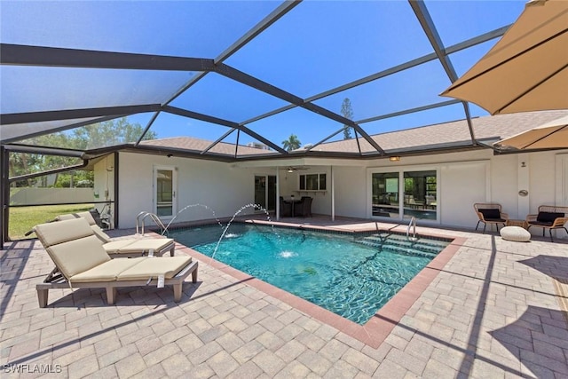 outdoor pool featuring a patio, ceiling fan, and glass enclosure