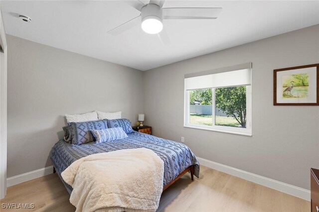 bedroom with baseboards, a ceiling fan, and wood finished floors
