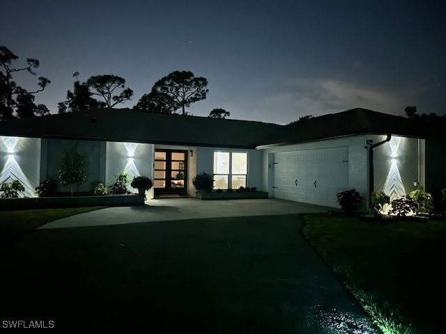 view of front of house with concrete driveway and a garage